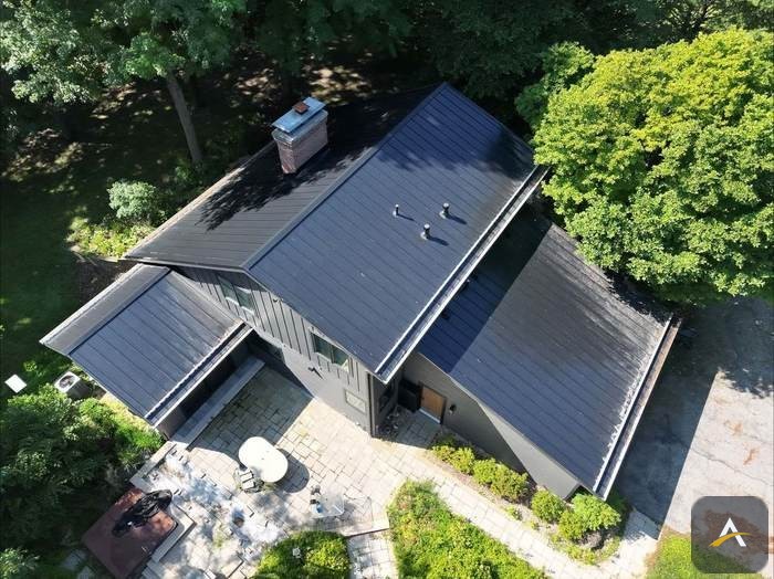 Completed black standing-seam metal roof