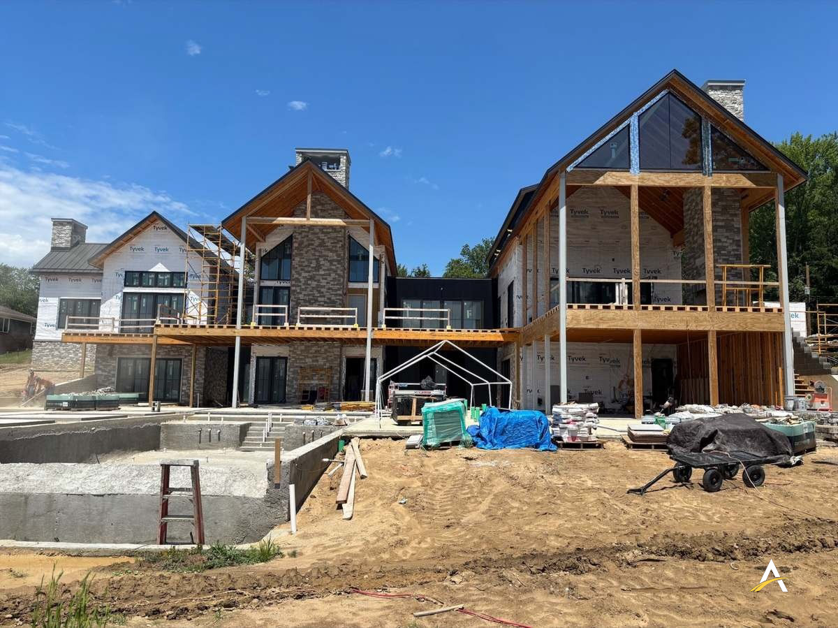Framing underway with stone chimney and deck