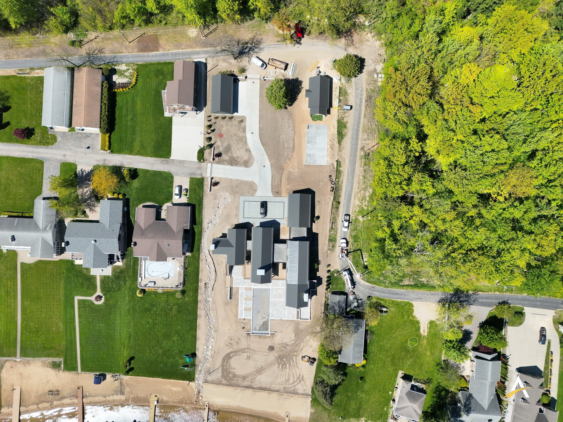Straight-down aerial view of the completed home and surrounding property