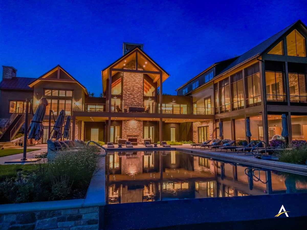 Twilight view of the completed home with pool reflection