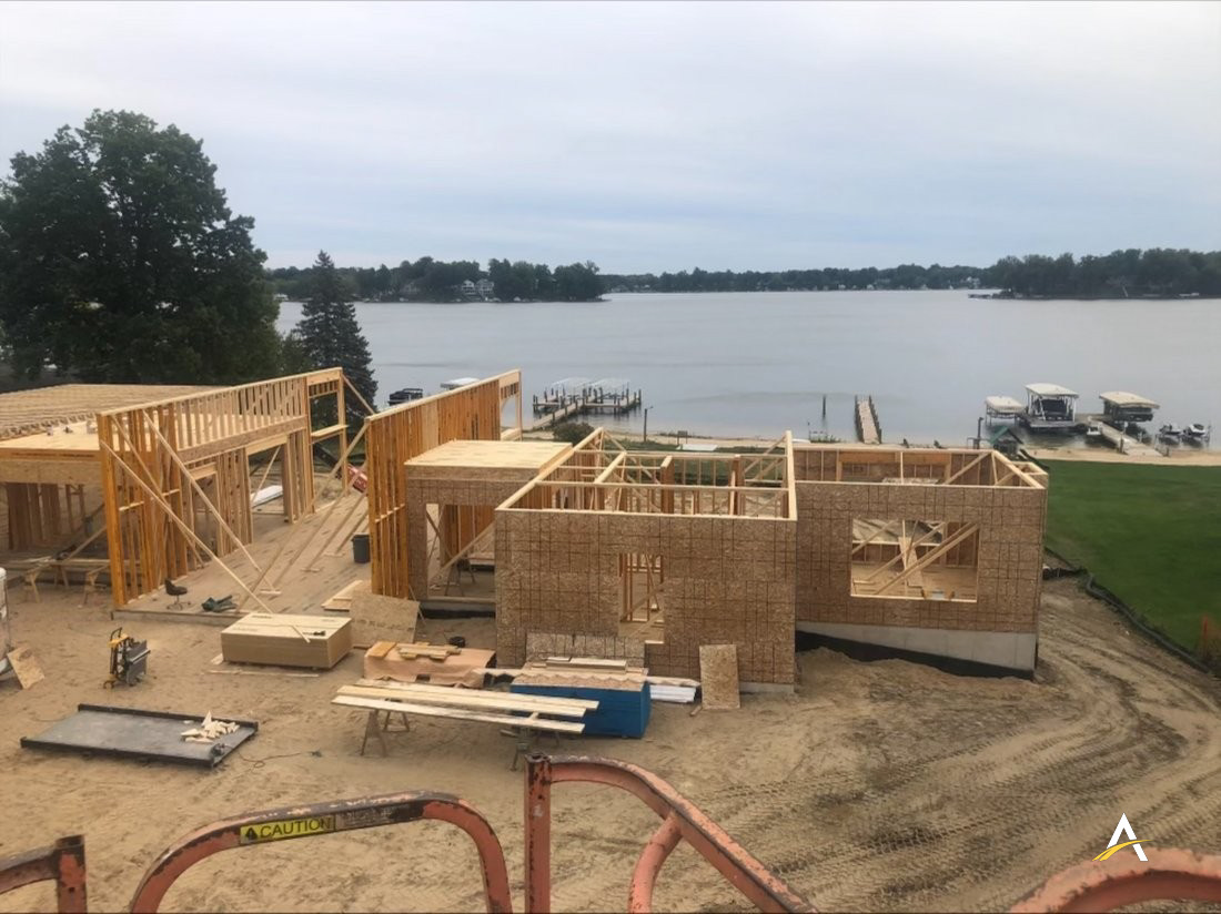 Wall framing underway with lake view in the background